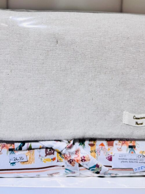 Funda de tela ecológica con estampado colorido en la parte inferior, presentada en un empaque transparente. Ideal para organizar y proteger objetos. Precio de $24.95.
